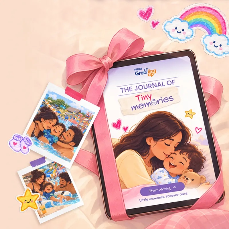 A Tiny Memories journal on a tablet tied with a pink ribbon, beside photos of a family laughing at a water park